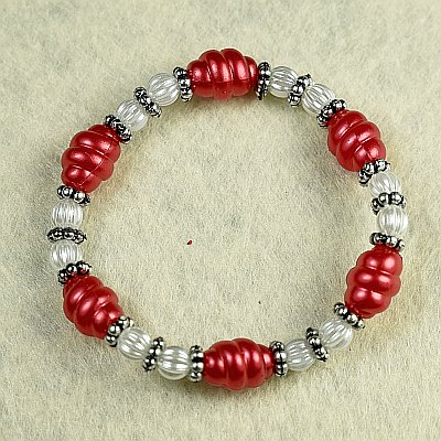 Гривна на ластик с червени усукани цилиндри и метални разделители PICTURE OF ITEM 1371